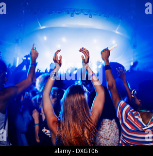Fans dancing and cheering at music festival Stock Photo