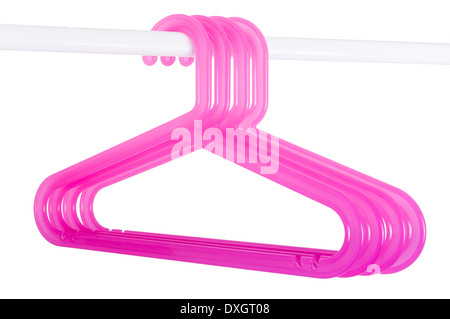 Pink plastic hangers hanging on a rod isolated on white background Stock Photo