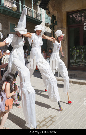 Three girls dancing on stilts in street Old Havana Cuba Stock Photo