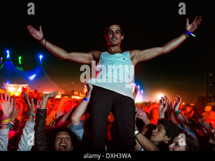 Portrait of confident performer with fans cheering in background Stock Photo