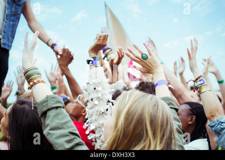 Fans reaching to shake hands with performer at music festival Stock Photo
