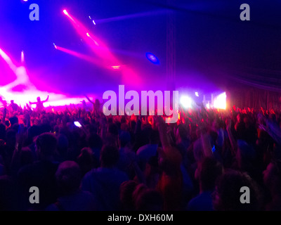 Crowd facing illuminated stage Stock Photo