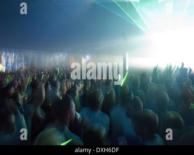 Crowd facing illuminated stage Stock Photo