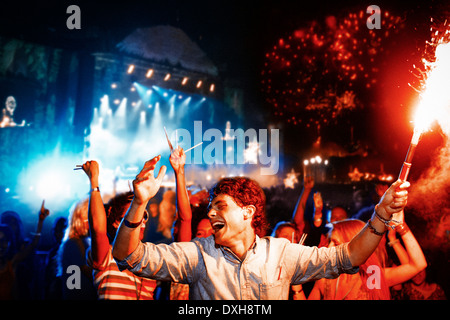 Fans with fireworks at music festival Stock Photo