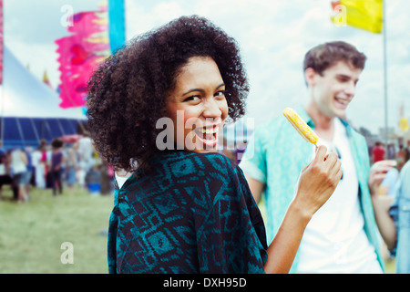 Portrait of woman eating flavored ice at music festival Stock Photo