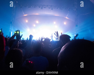 Silhouette of crowd facing stage at music festival Stock Photo