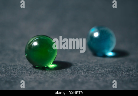 Glass marble balls isolated on dark background. Selective focus with shallow depth of field. Stock Photo
