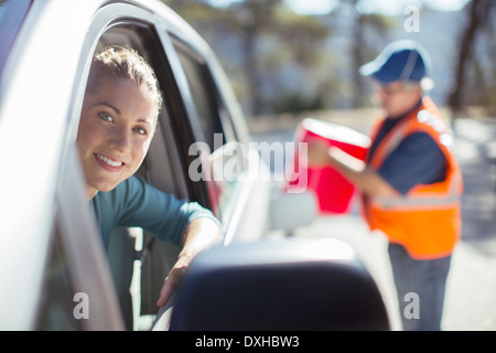 Roadside mechanic filling gas tank for woman Stock Photo