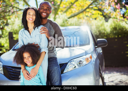 Portrait of happy family outside car Stock Photo