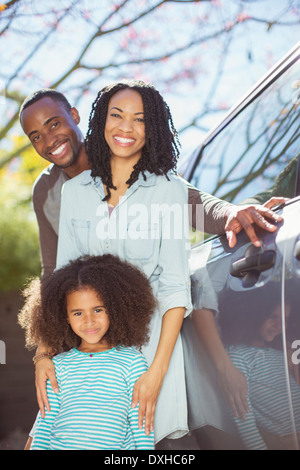 Portrait of happy family outside car Stock Photo