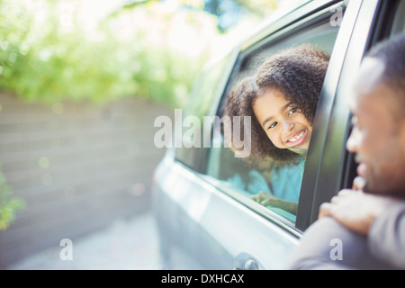 Father and daughter leaning out car windows Stock Photo