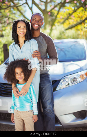 Portrait of happy family outside car Stock Photo