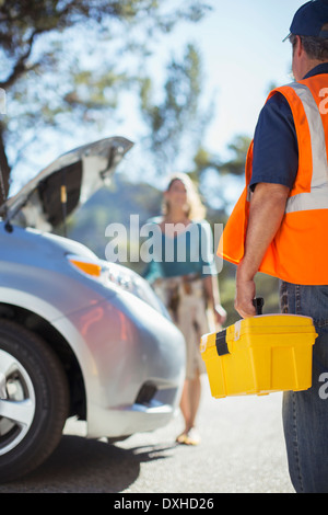 Roadside mechanic arriving to help woman Stock Photo