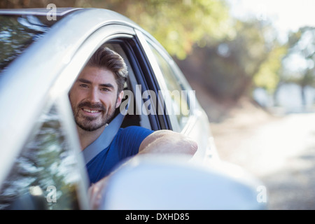 Portrait of happy man driving car Stock Photo