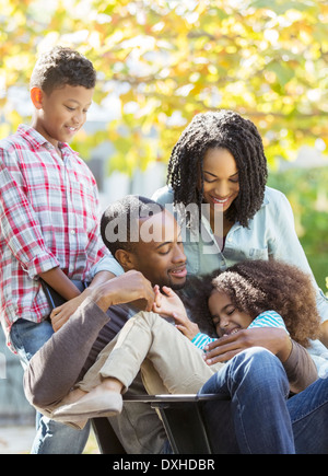 Happy family hugging outdoors Stock Photo