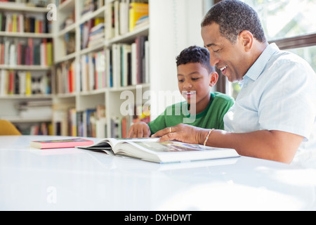 Grandfather and grandson reading book Stock Photo