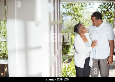 Senior couple hugging on patio Stock Photo