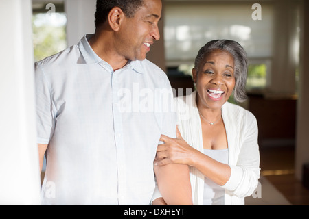 Laughing senior couple in doorway Stock Photo