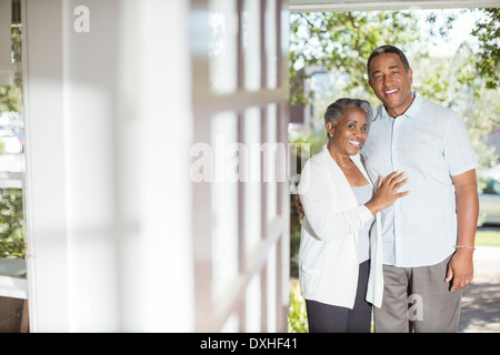 Portrait of smiling senior couple in doorway Stock Photo