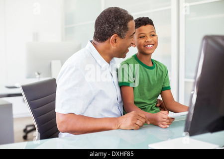 Grandfather and grandson using computer Stock Photo