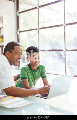 Grandfather and grandson using laptop Stock Photo