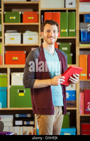 Portrait of confident creative businessman holding digital tablet Stock Photo