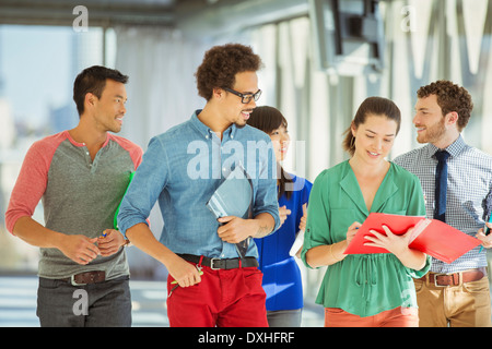 Creative business people walking in office corridor Stock Photo