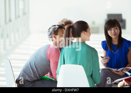 Creative business people meeting in circle of chairs Stock Photo