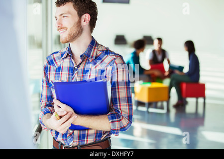 Distracted casual businessman looking out window outside meeting Stock Photo