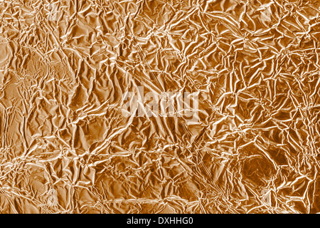 Wrinkled bronze aluminium foil background Stock Photo