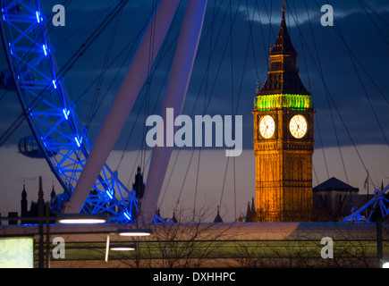 Big Ben Clock Tower of Houses of Parliament and Millennium Wheel or London Eye at dusk London England UK Stock Photo