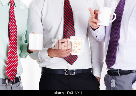 Indian Businessman Standing and Drinking Tea Stock Photo