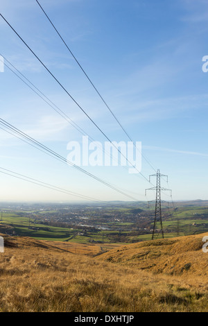 Electricity pylons carrying part of the National Grid over Blackstone Edge and down into the Roch valley towards Littleborough. Stock Photo