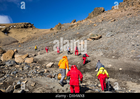 Passengers on an expedition cruise climbing the caldera on Deception Island in the South Shetland Islands off Antarctica Stock Photo