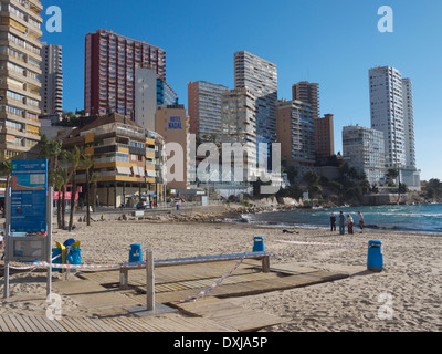 People on a beach in Benidorm, Spain with hotels and apartment buildings. Stock Photo