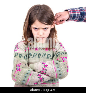 Young girl being punished with ear pulling Stock Photo