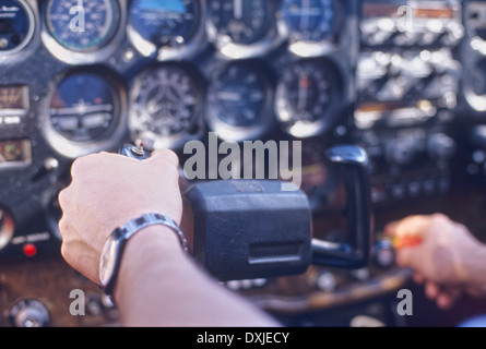 Pilot handling controls close-up (focus on hand) Stock Photo