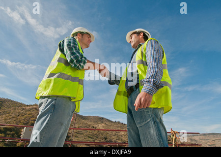 Two construction engineers shaking hands Stock Photo