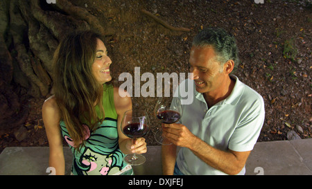 Couple drinking red wine in outdoors setting Stock Photo