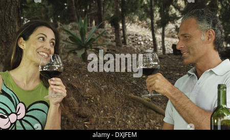 Couple drinking red wine in outdoors setting Stock Photo