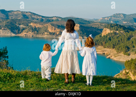 Spain Malaga mother and children looking at lake rear view Stock Photo