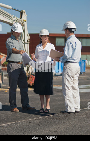 female and male architects in construction site Stock Photo
