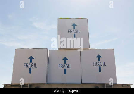 Removal boxes piled on crate low angle Stock Photo