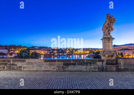 Statue and cobblestones on Charles Bridge at dawn, Prague, Czech Republic Stock Photo