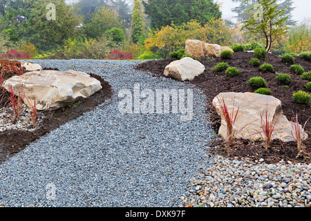 Gravel path and rocks in landscaped garden Stock Photo