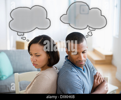Thought bubbles above frustrated couple Stock Photo