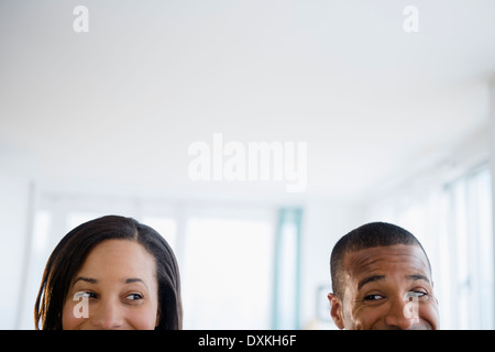 Couple engaged in sideways glance Stock Photo