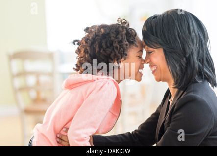 Black mother and daughter rubbing noses Stock Photo