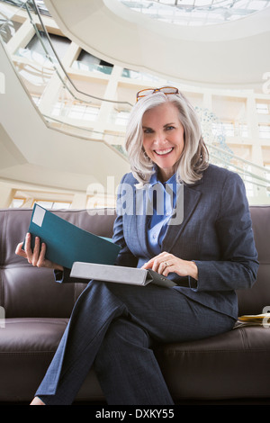 Smiling Caucasian businesswoman using digital tablet Stock Photo