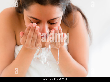 Close up of Asian woman washing face Stock Photo